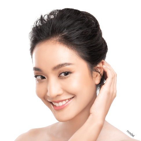 Injectables Procedure Beautiful woman with perfect skin, brushing hair behind ear.